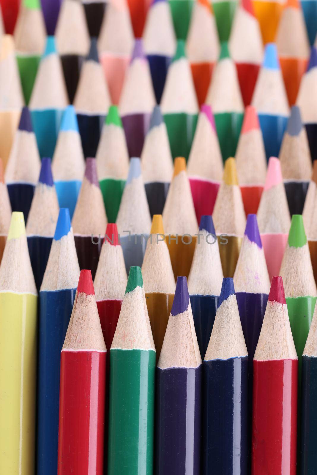 Closeup of assortment of colored pencils. Assortment stack of colored wood drawing pencils closeup