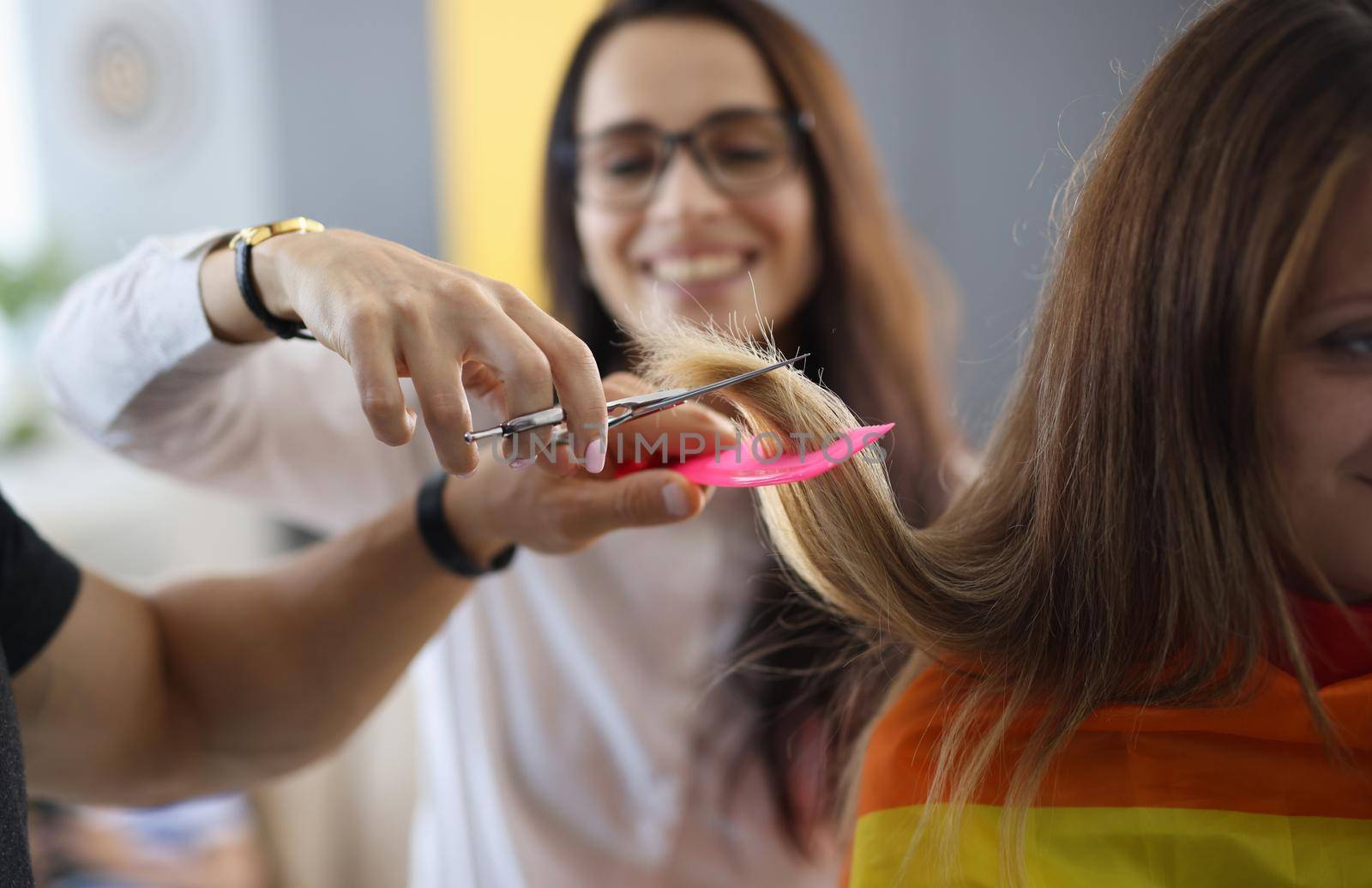 Student in hairdressing is learning how to cut hair. Training profession hairdresser concept