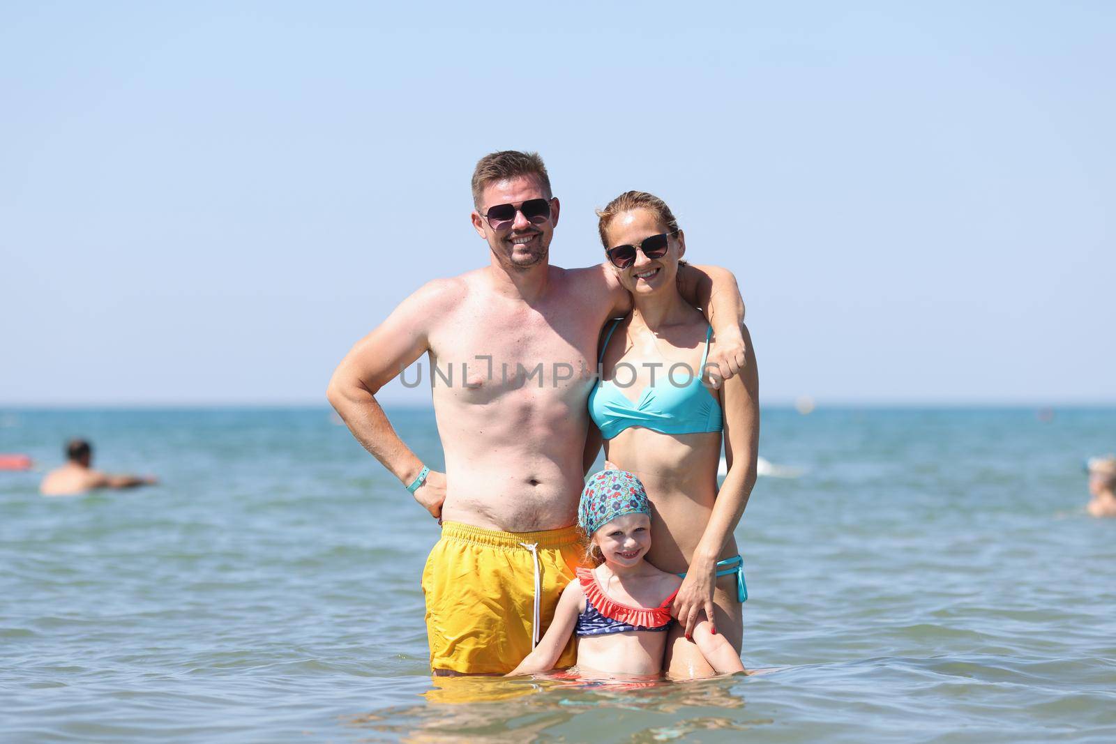 Happy family have fun on beautiful warm sunny beach in sea by kuprevich