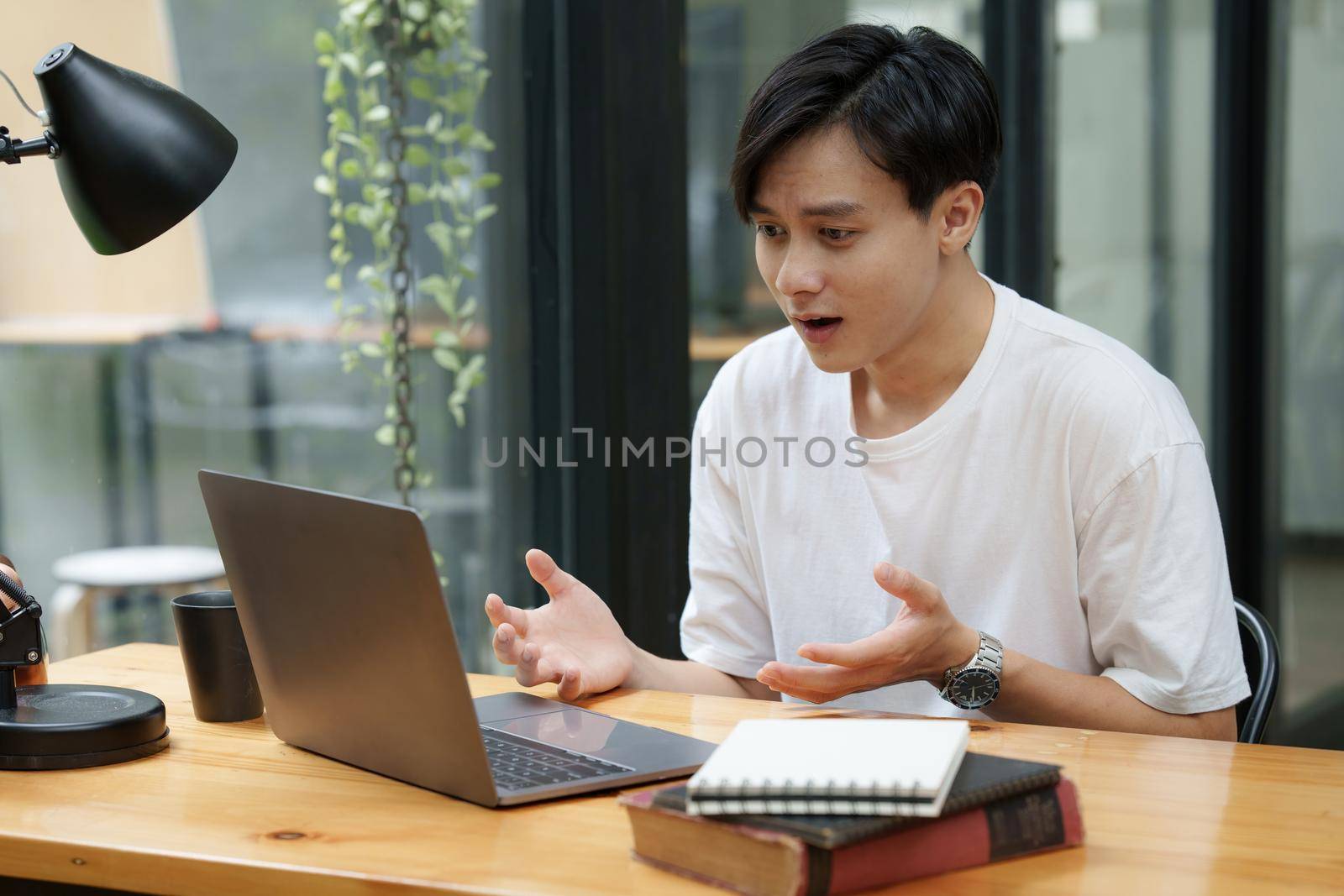 Asian man have video call meeting with partner by laptop computer.