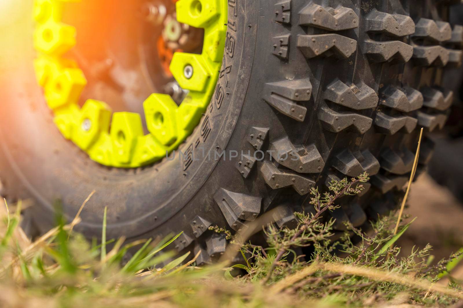 Close-up of the ATV wheel on sandy ground. by audiznam2609