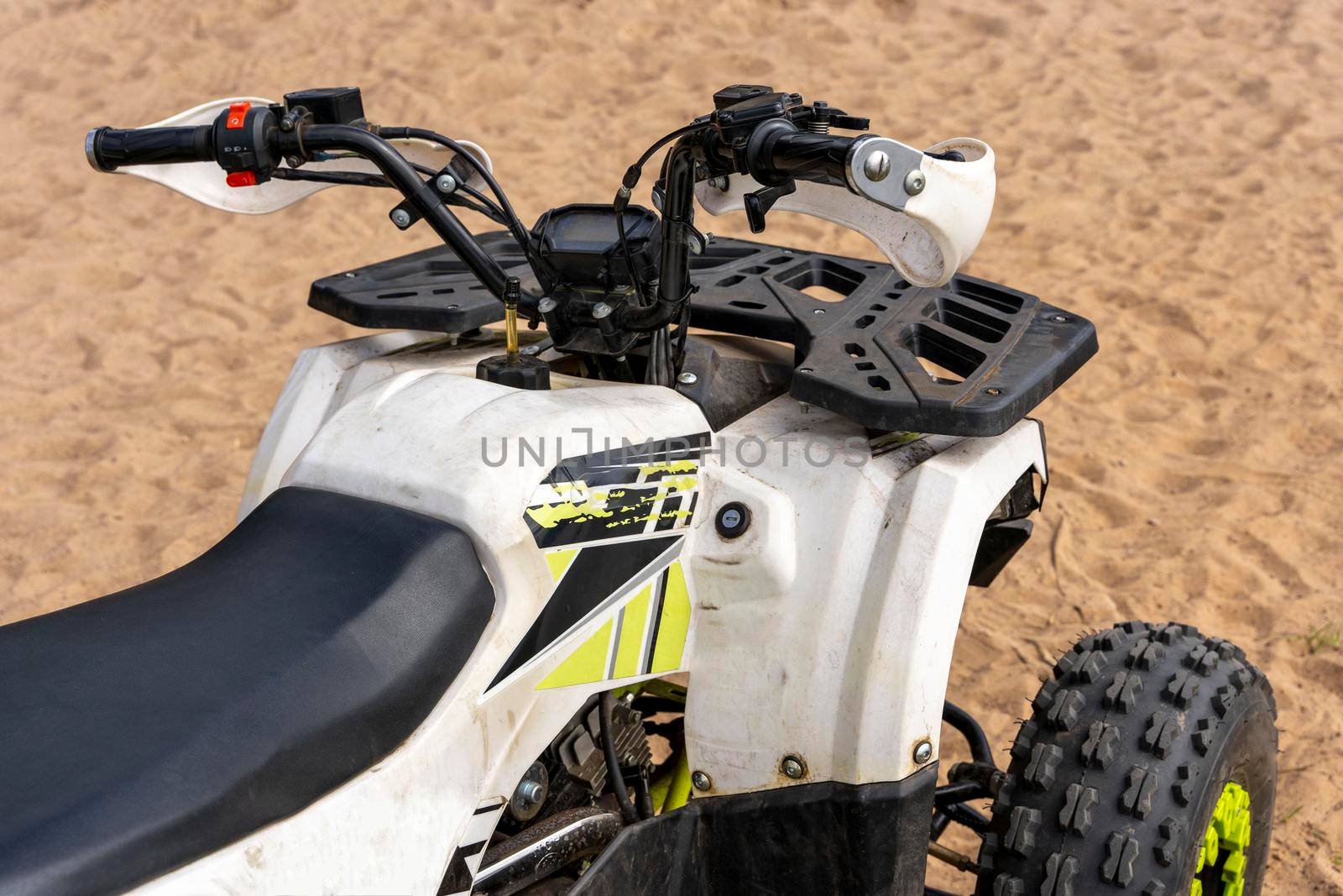 Children 's and youth quad bike on the sandy shore of the lake by audiznam2609