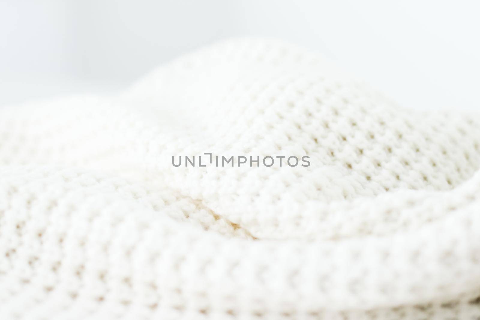 Knitwear, fabric textures and handmade items concept - Warm knitted clothes, soft and white