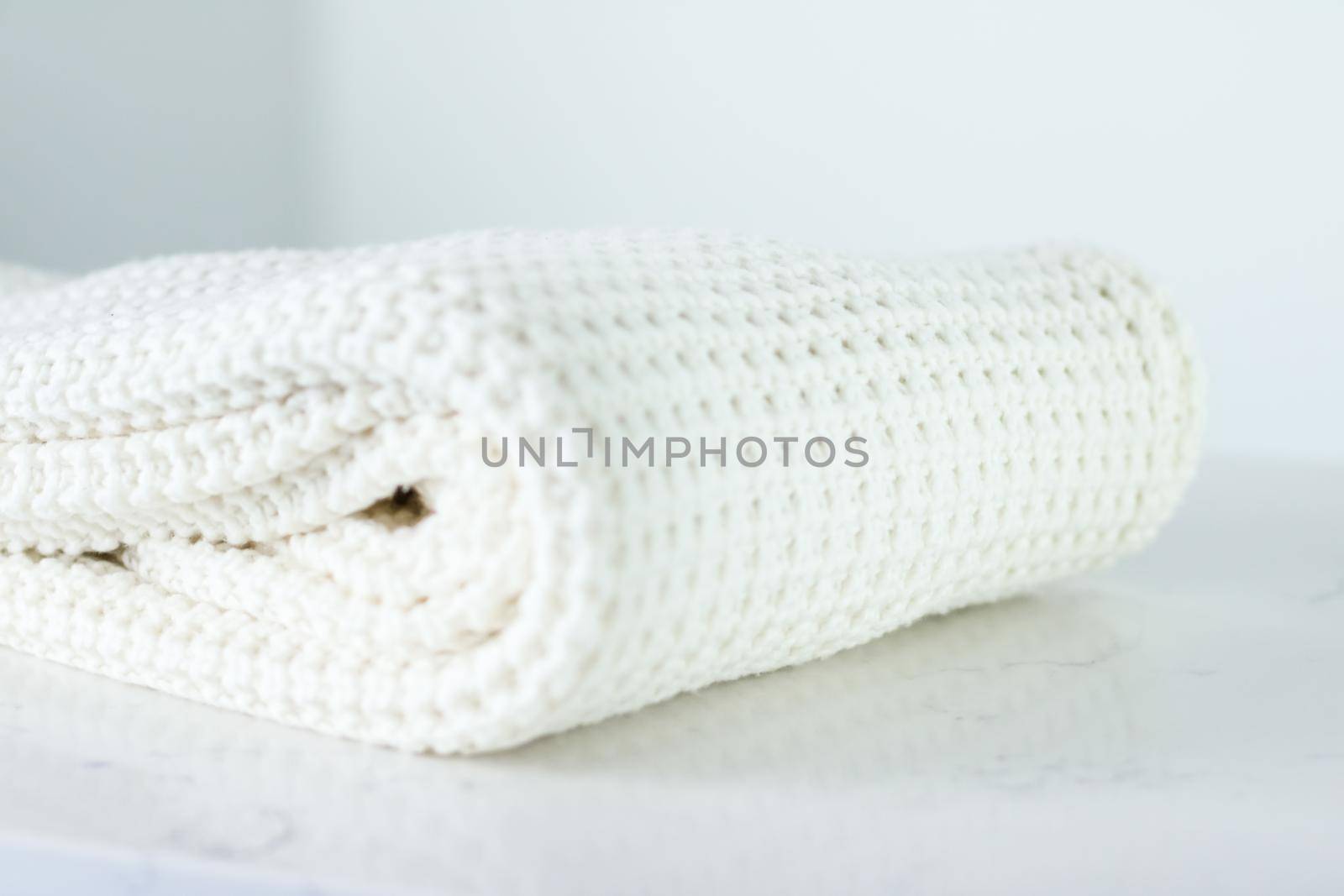 Knitwear, fabric textures and handmade items concept - Warm knitted clothes, soft and white