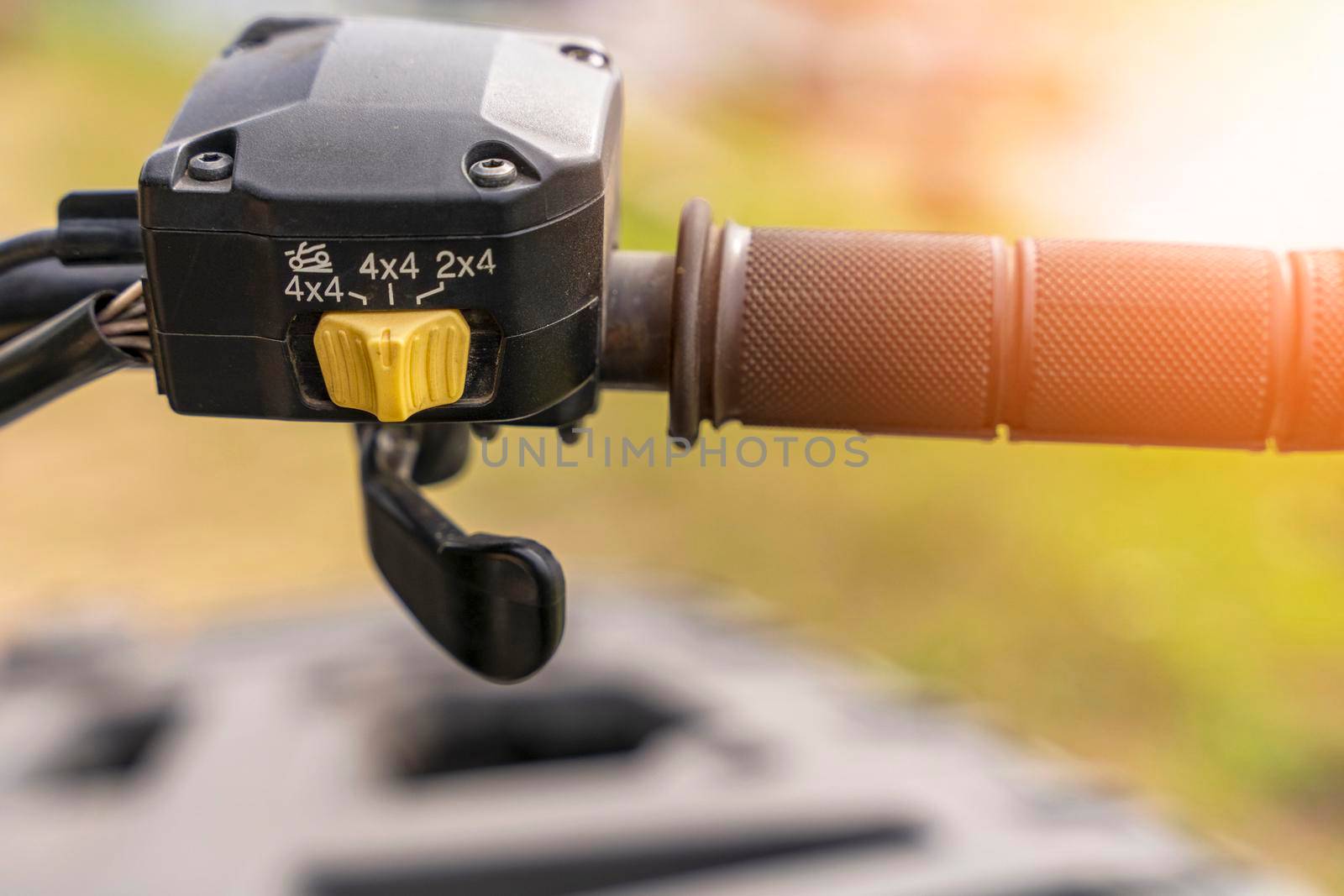 atv controls close-up. switches on the handlebar of the ATV. rubber grips