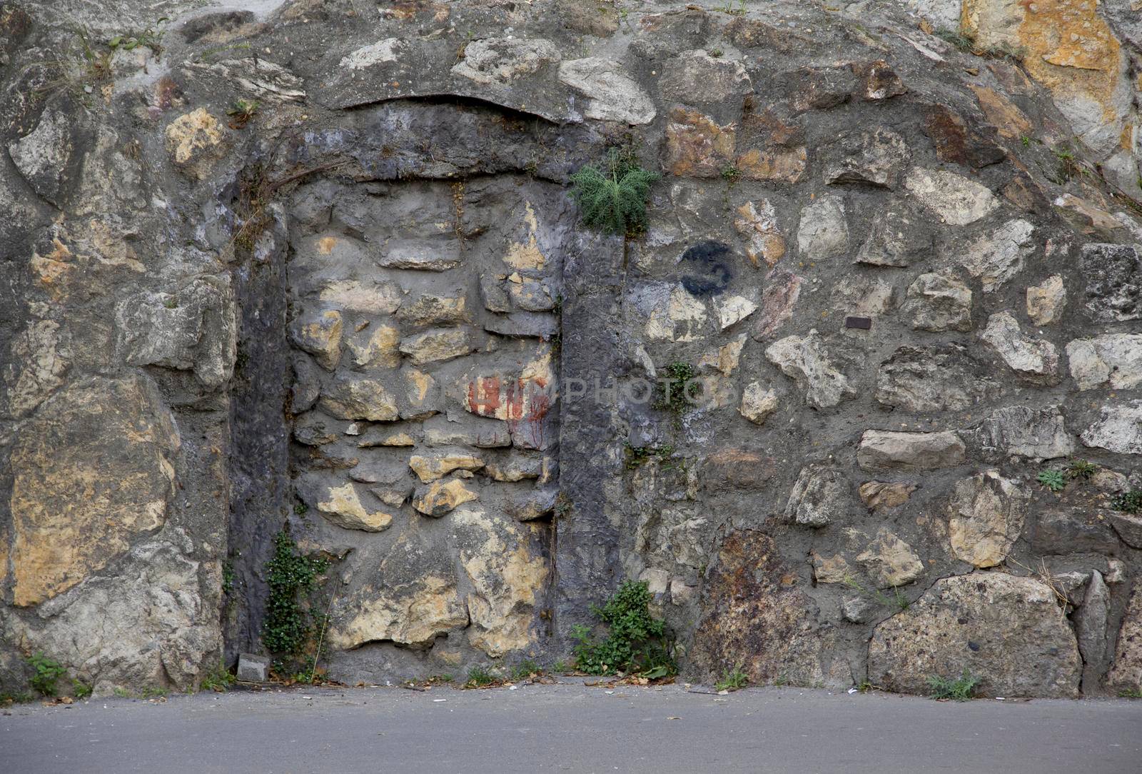 A stone building that has a rocky cliff. background