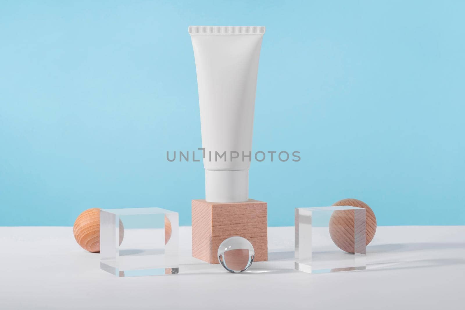 Medical skincare and cosmetic cream mockup on wooden block pedestal podium with stylish props, glass acrylic balls. Lotion, concealer beauty product packaging. Product presentation mock up