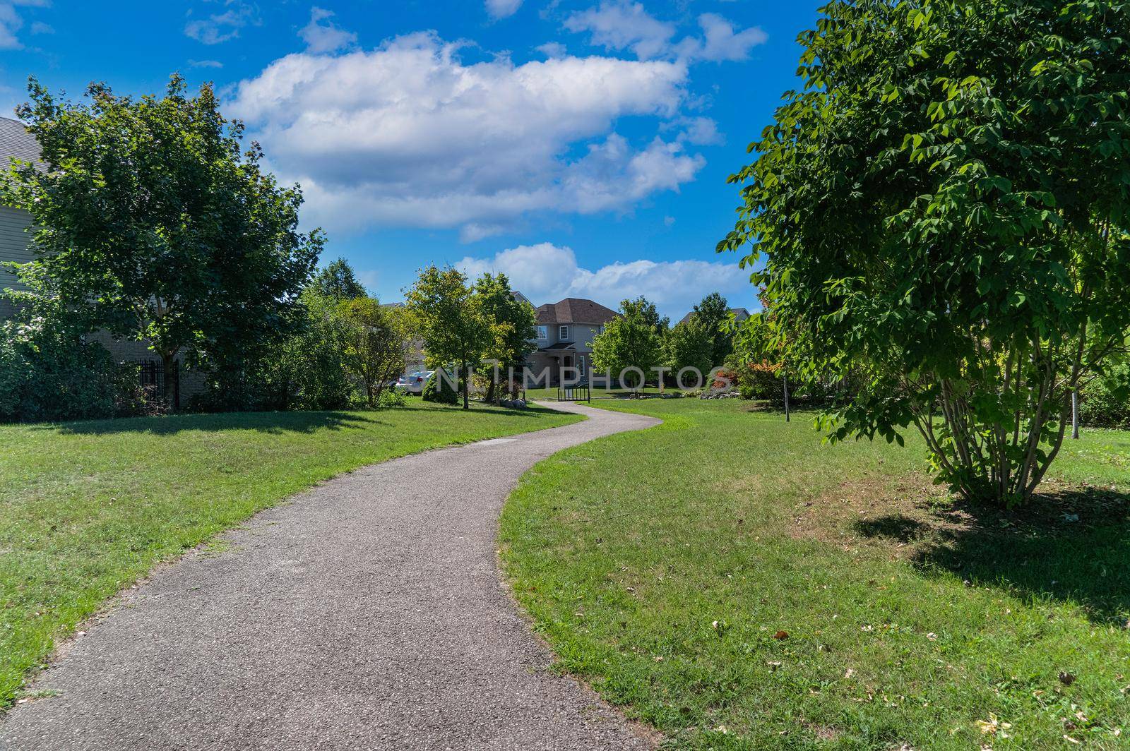 The road to the holiday village under the blue sky with white clouds