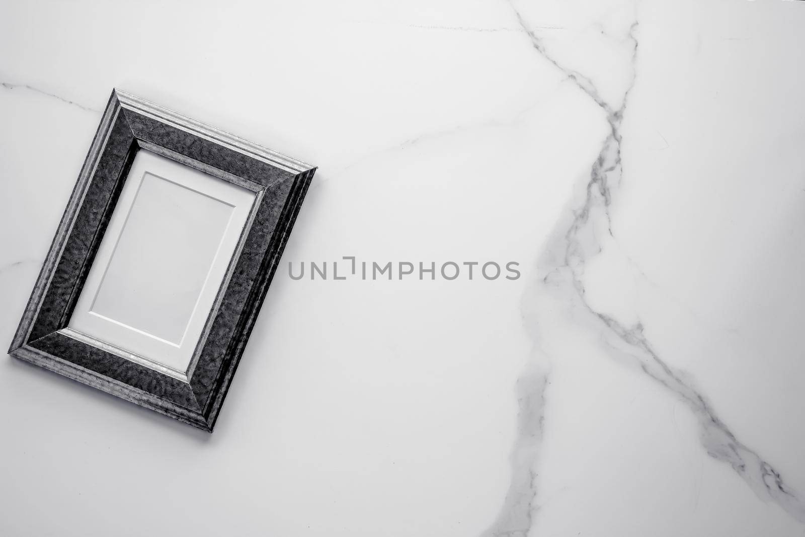 Black photo frame on marble, flatlay by Anneleven