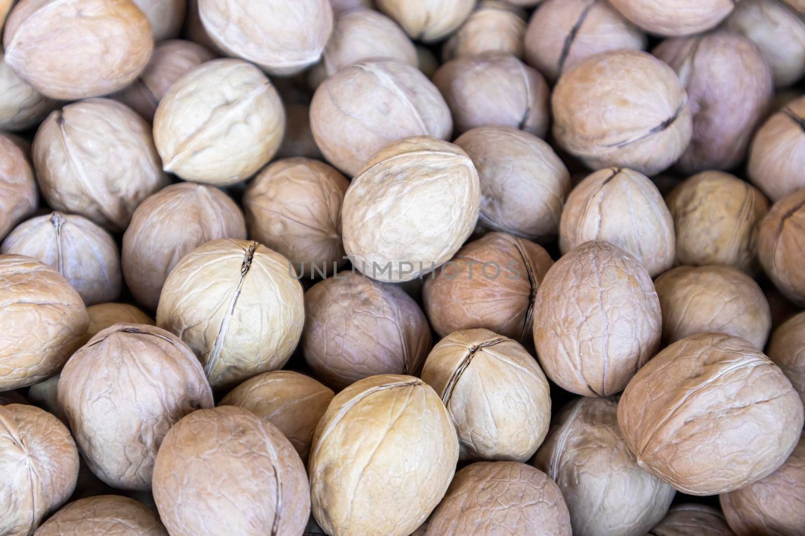 ripe fruits in walnut shell close-up as background by roman112007