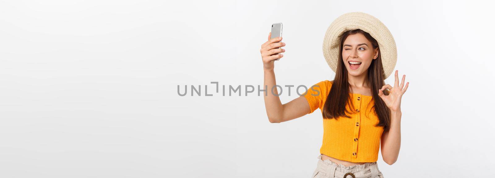 Young Caucasian woman enjoying the selfie with herself isolated on white background summer travel concept. by Benzoix
