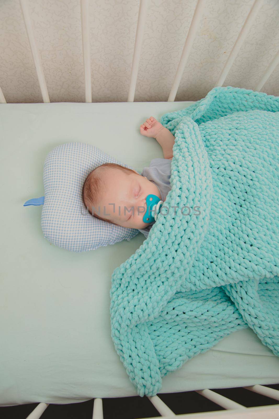 The baby is sleeping in the crib. Sweet baby 's dream . An article about children.