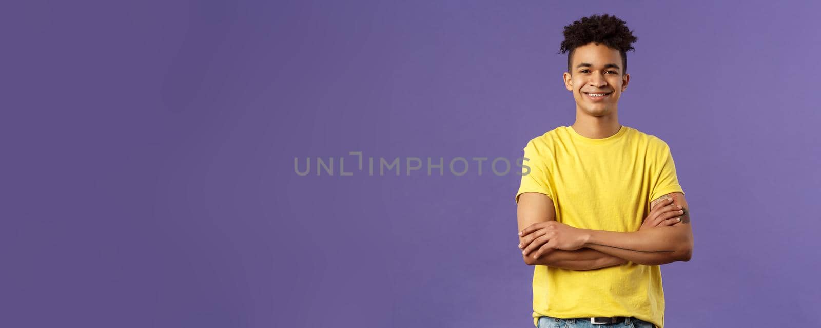 Close-up portrait of confident, smart and professional young male student with dreads, yellow t-shirt, cross arms over chest and smiling pleased, knows what he doing, purple background by Benzoix