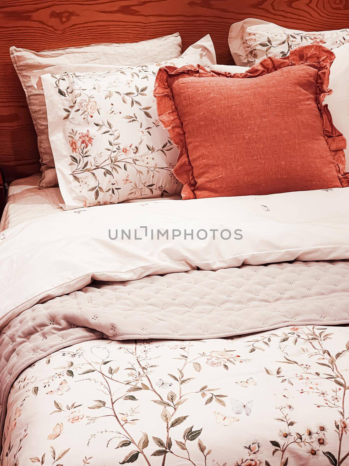 Vintage countryside style bedding with floral pattern on wooden bed in bedroom, interior design detail