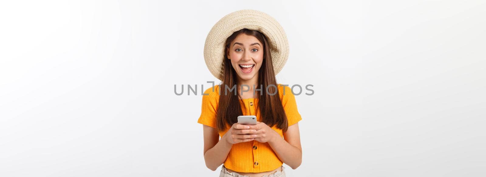 Happy young caucasian woman using smartphone standing isolated on white