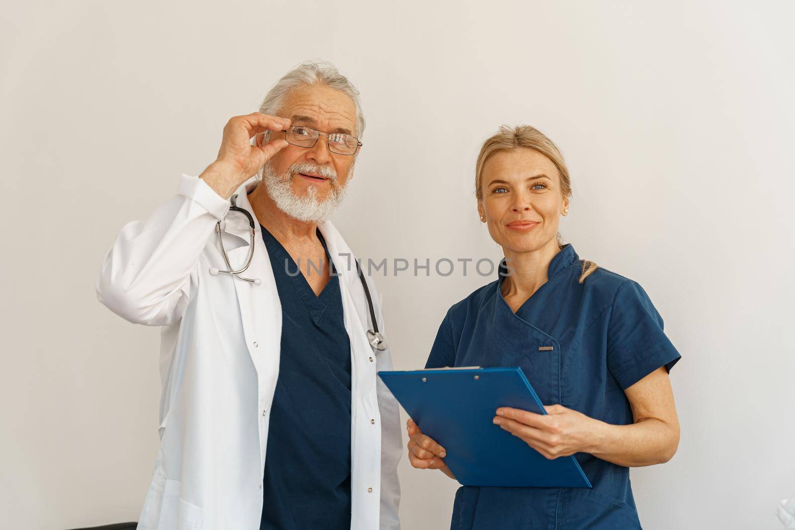 Two doctors colleague in uniform standing in medicine clinic and looking camera. High quality photo