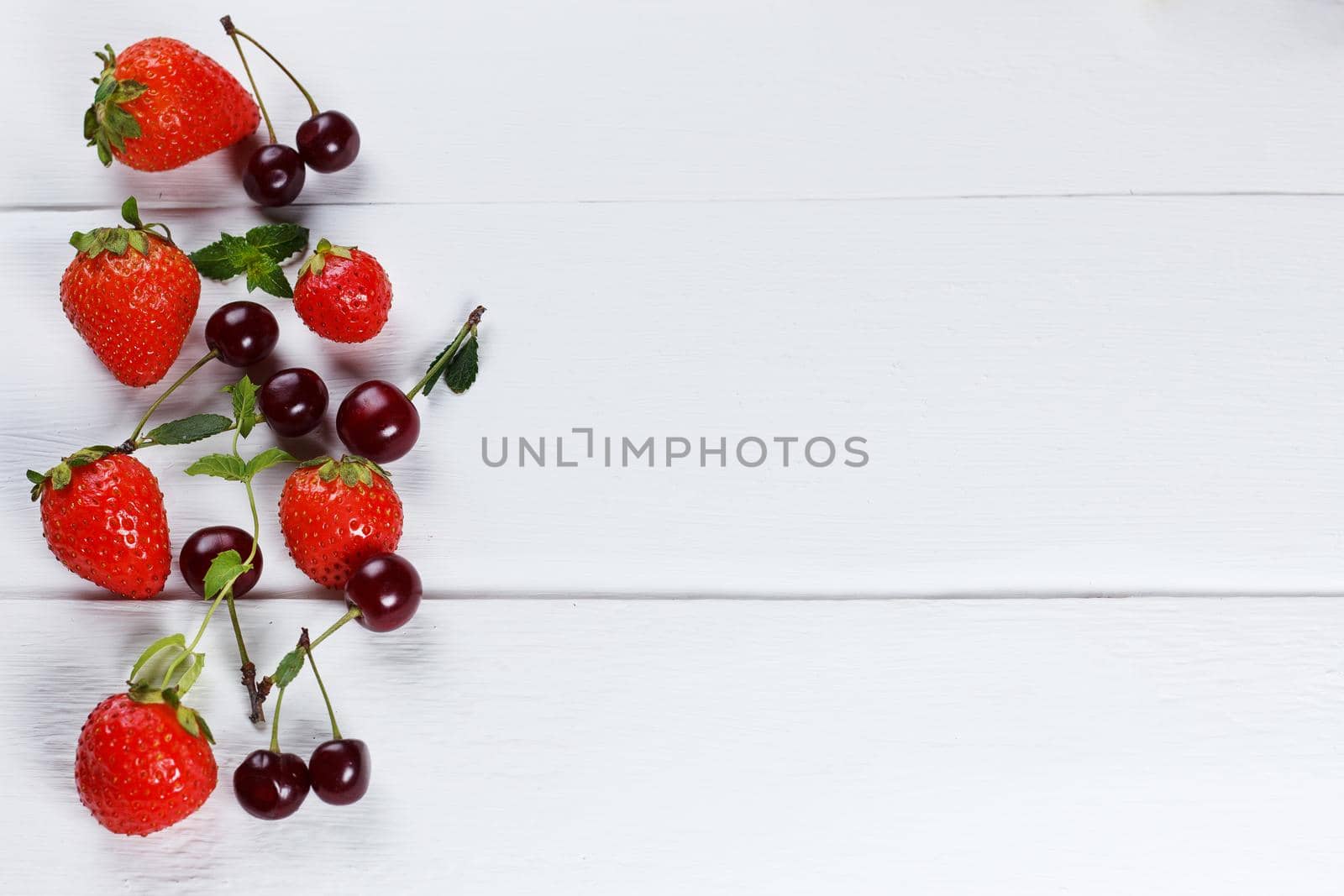 Various fresh berries on a wooden background. copy space