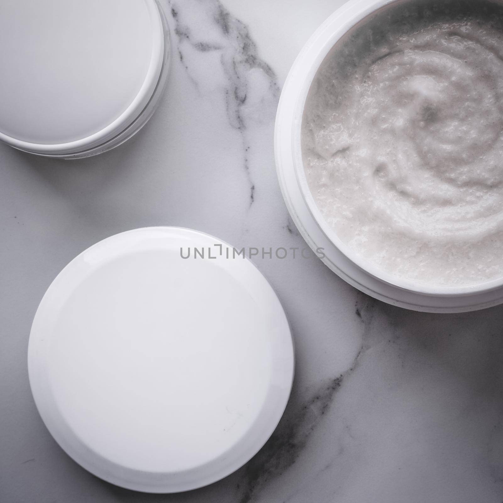 Scrub and exfoliating cream products on a marble, flatlay by Anneleven