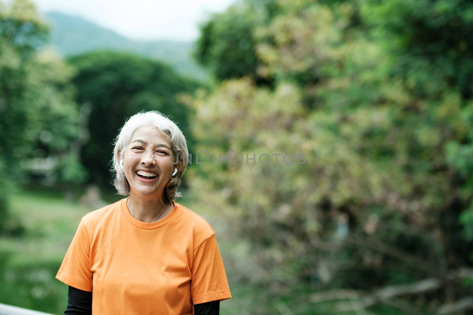 Happy athletic Senior woman in park. by ijeab