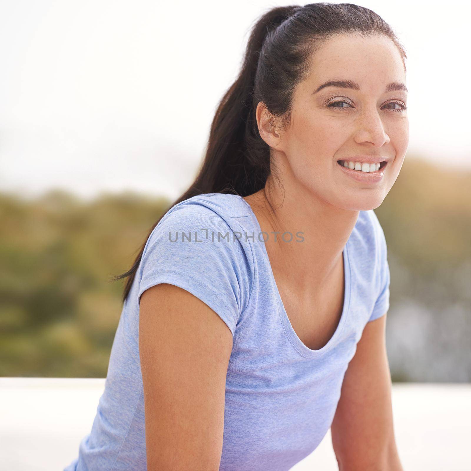 Looking forward to great work out. Cropped portrait of a young woman doing yoga outdoors. by YuriArcurs