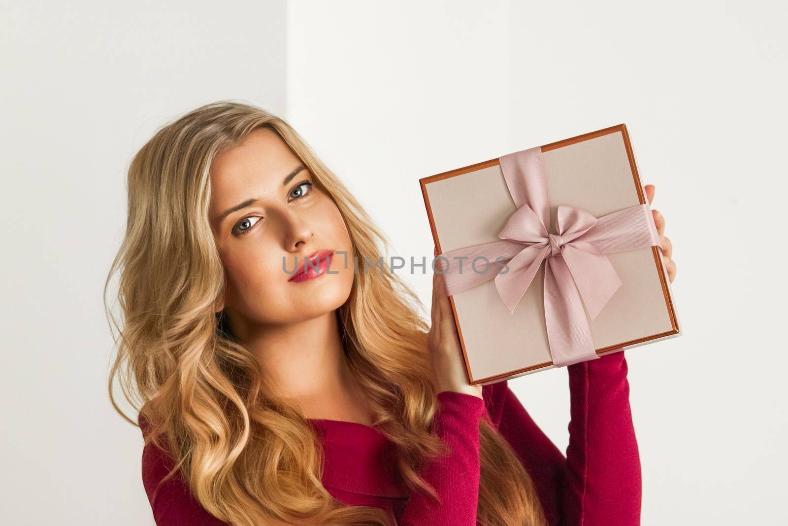 Happy woman holding a gift for birthday, anniversary, wedding, Valentines day or Christmas, luxury holiday present or beauty box subscription delivery concept