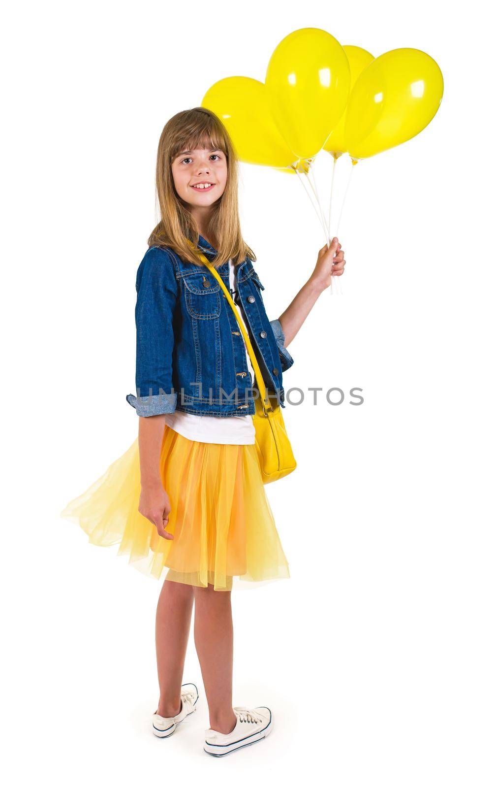 joy on the girl face holding yellow balloons on a light background by aprilphoto