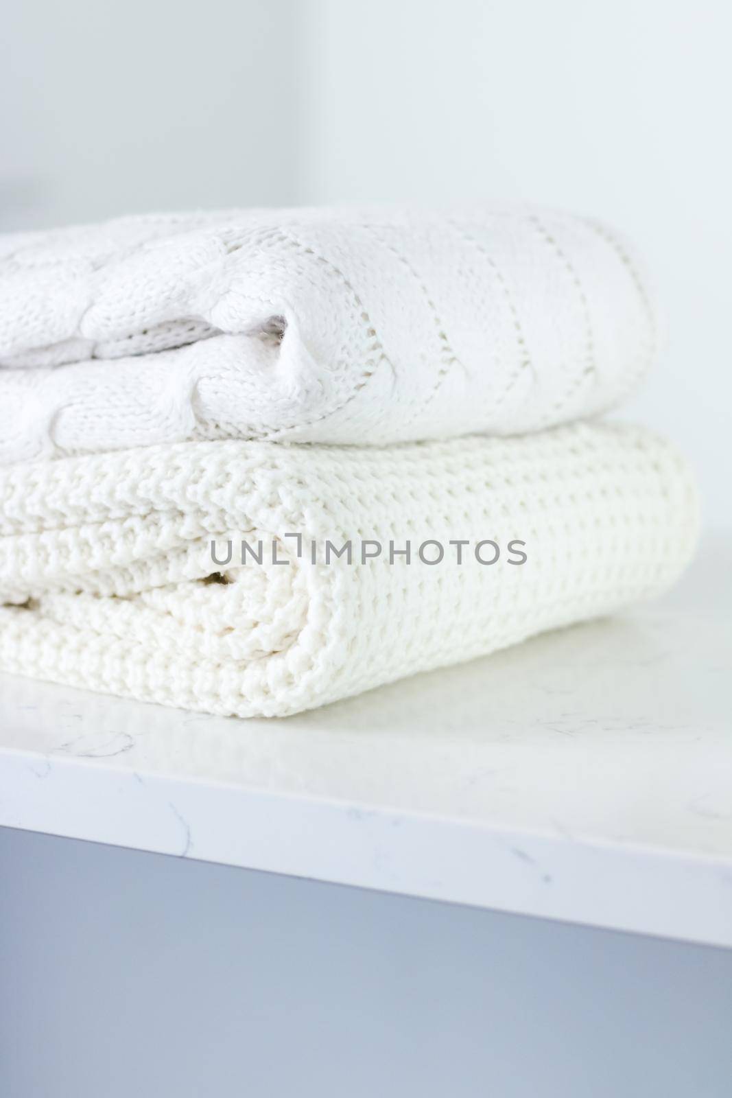 Knitwear, fabric textures and handmade items concept - Warm knitted clothes, soft and white