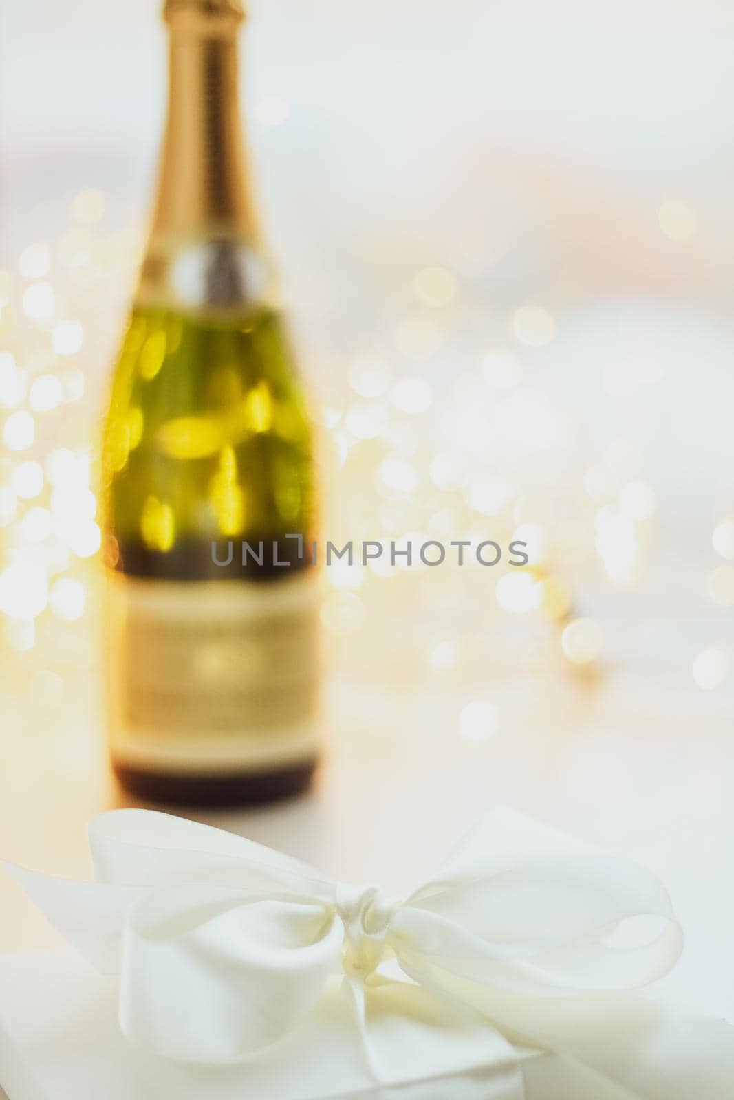 Romantic celebration, lifestyle and luxury present concept - The bottle of champagne and holiday gift box