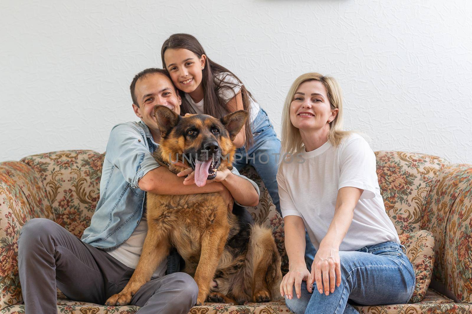 Portrait of happy family with a dog having fun together at home.