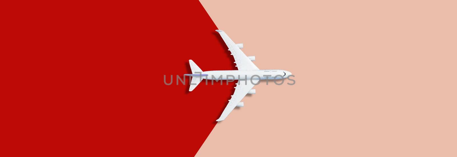 Flat lay design of travel concept with plane on pink red runway back by Andelov13