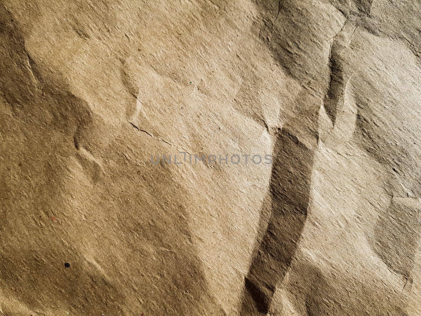 Texture of crumpled brown craft paper, background.