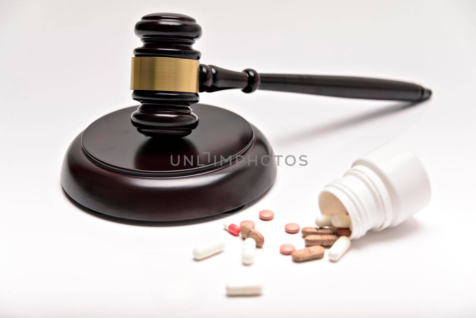 Medicine law concept. Gavel, stethoscope and pills isolated on white