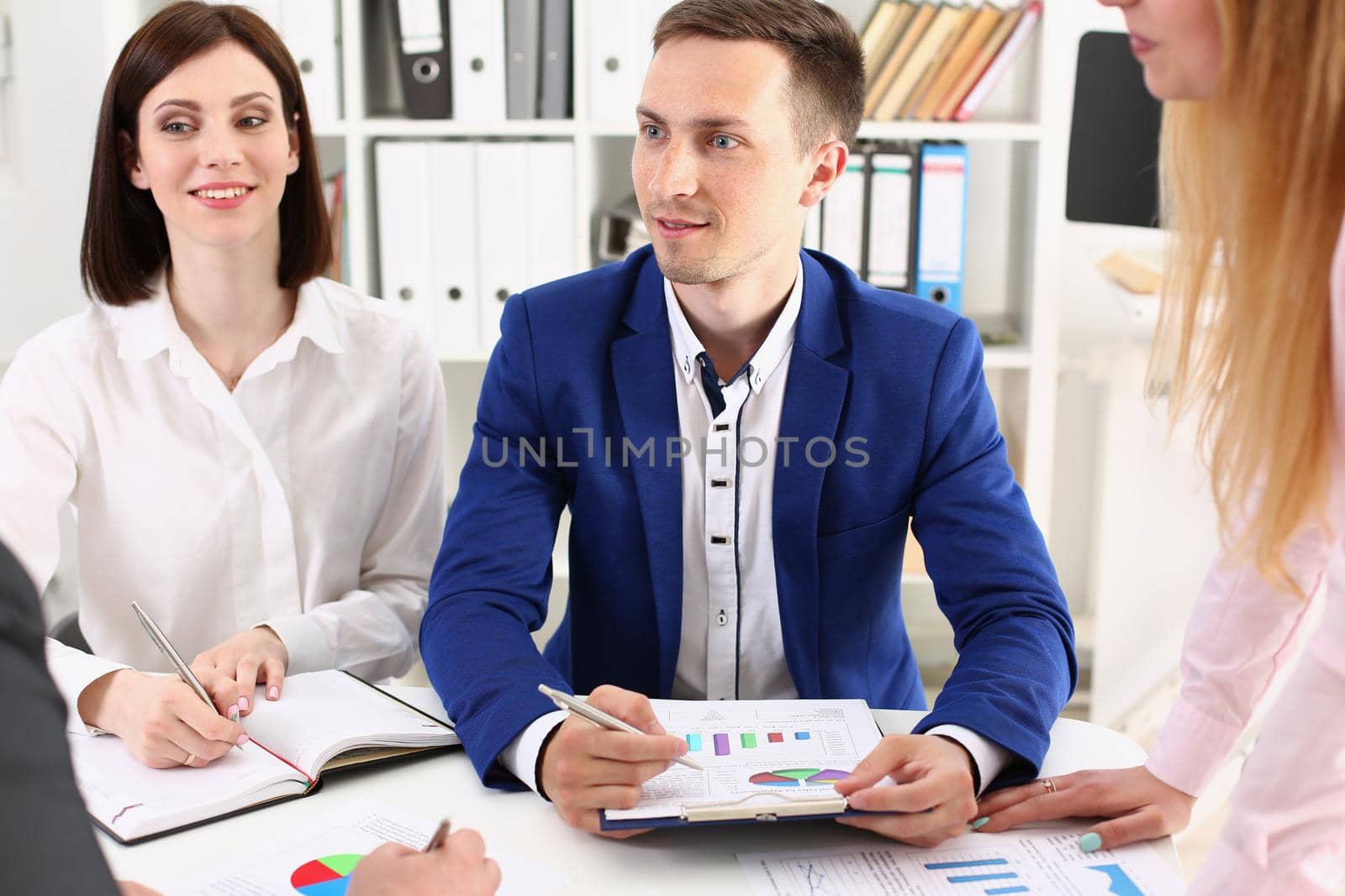 Group of modern business people working with financial chart by kuprevich