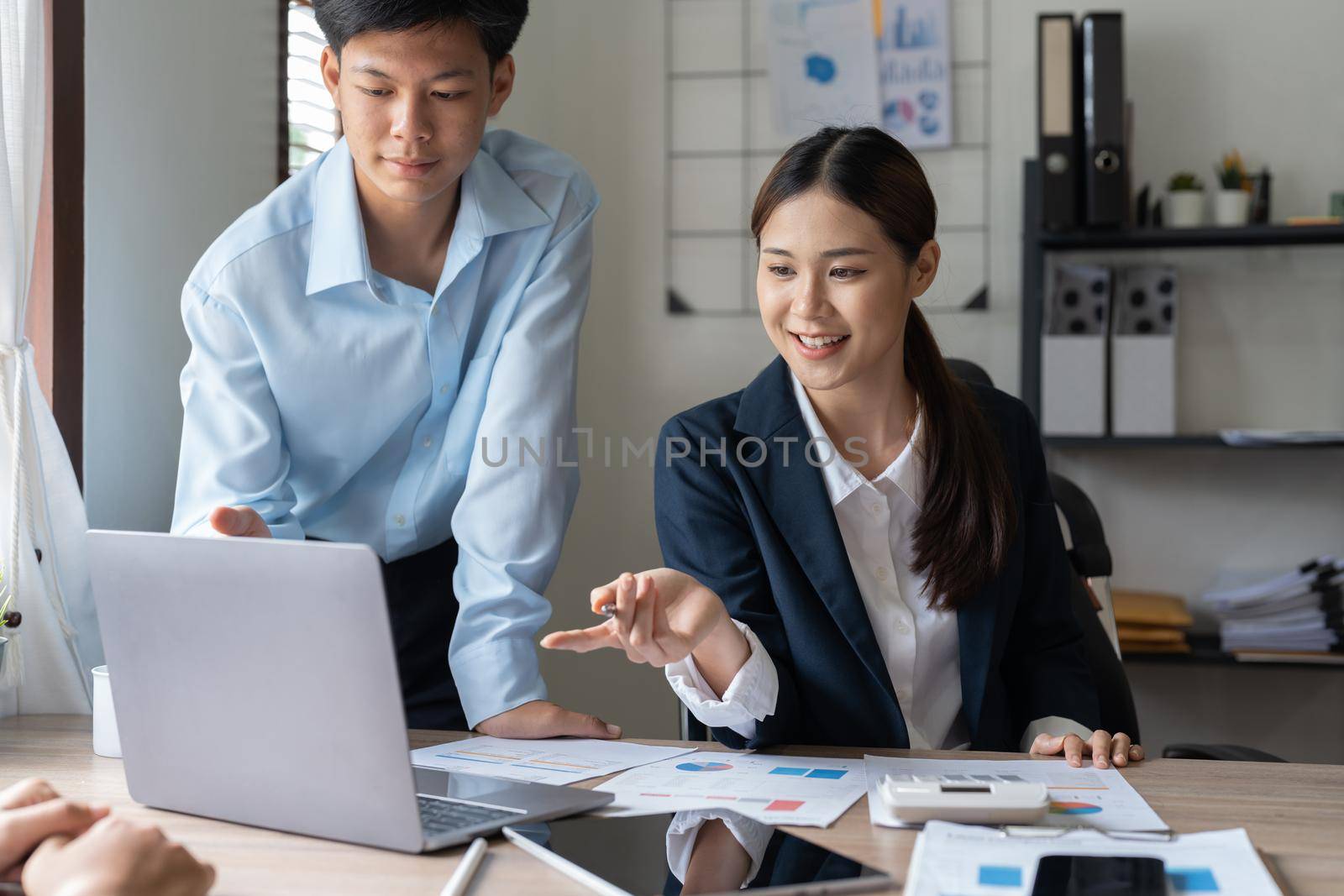 Asian business adviser meeting to analyze and discuss the situation on the financial report in the meeting room.Investment Consultant, Financial advisor and accounting concept.