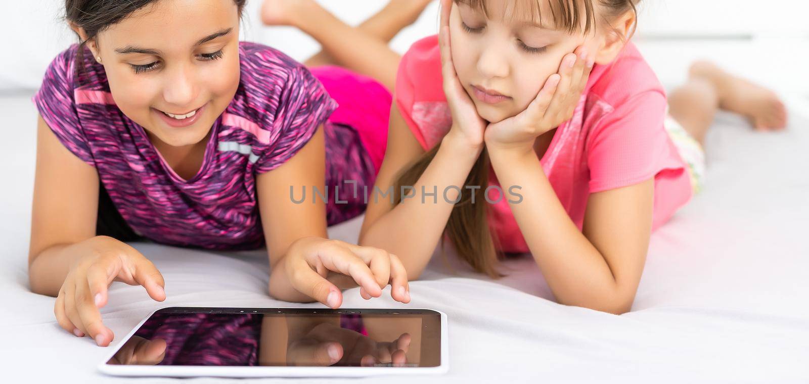 Little girls using tablet computer as art board - painting together.