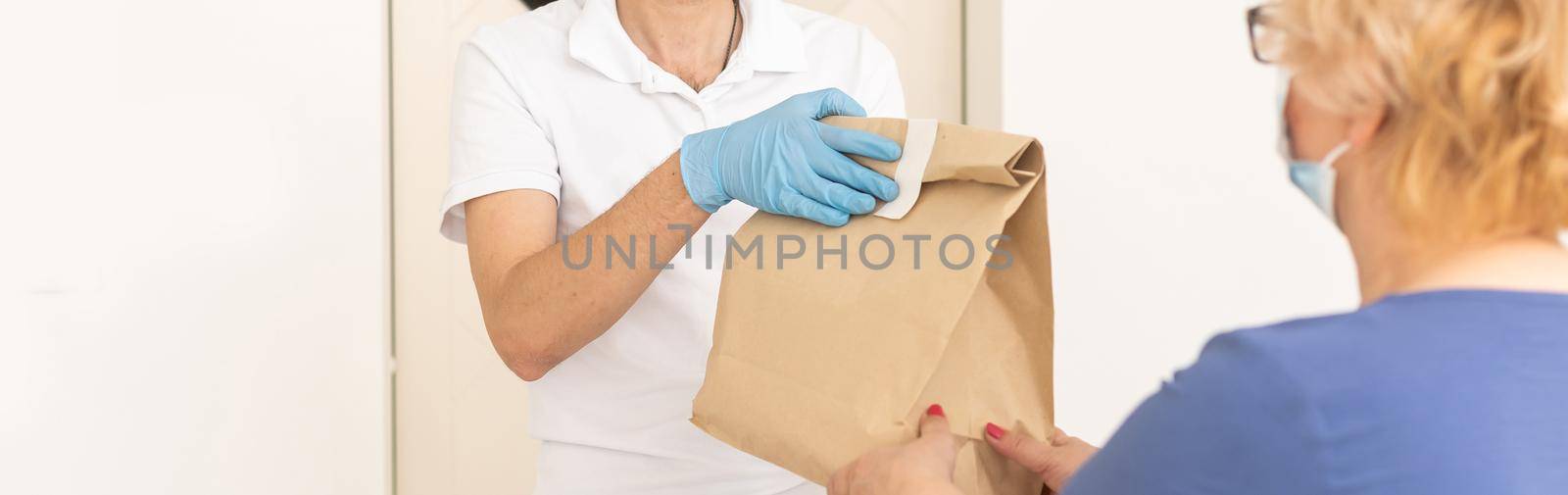 Food delivery to an elderly woman during quarantine Coronavirus Covid-19 epidemic.