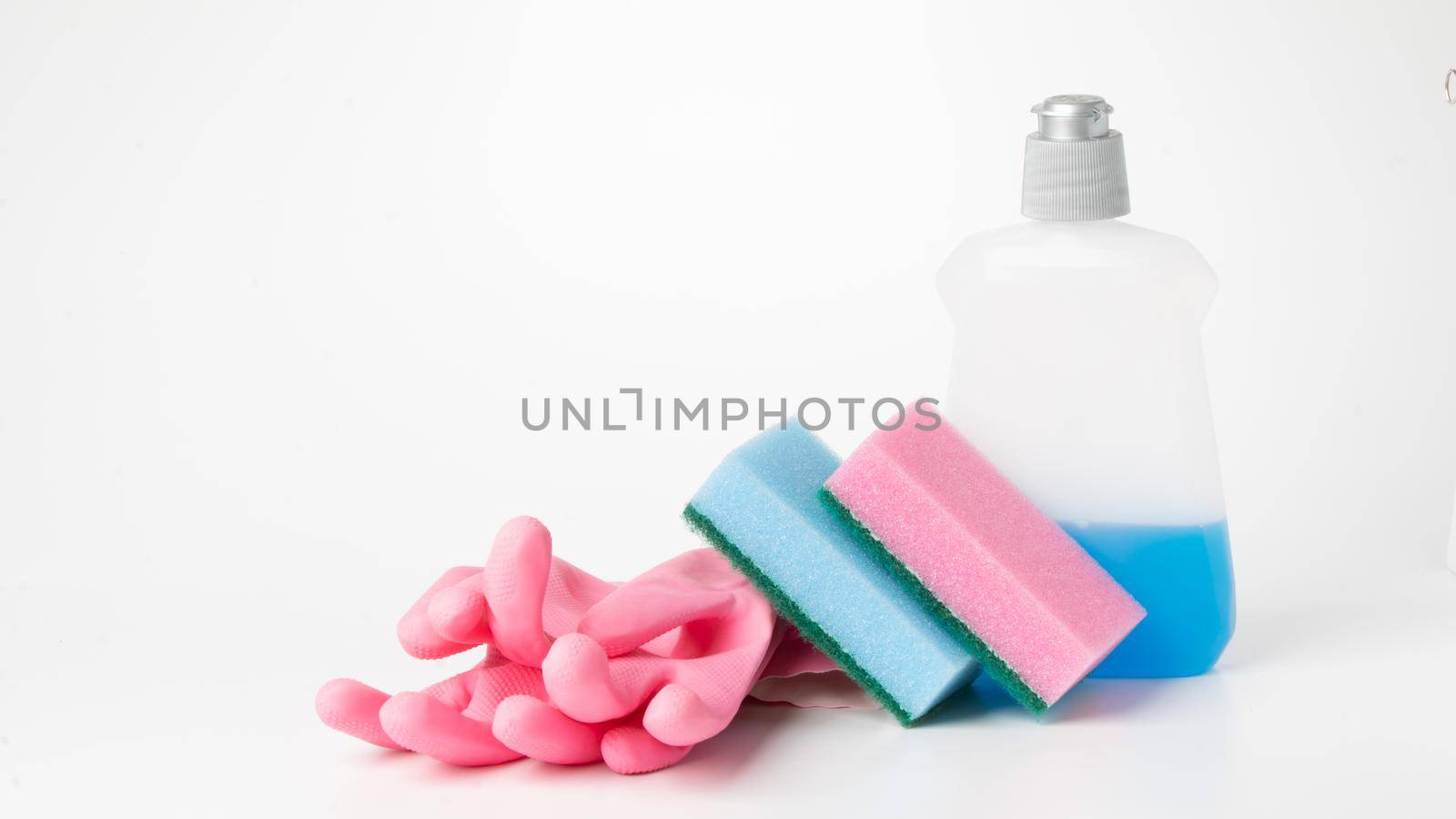 Detergent, sponges and rubber gloves on a white background. High quality photo