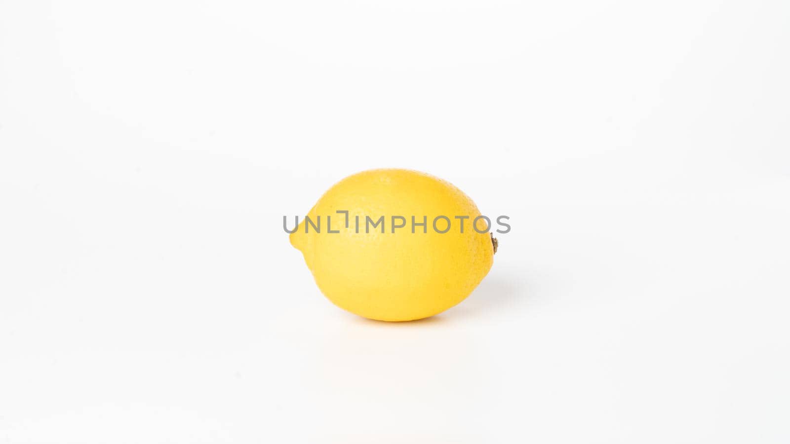 Yellow lemon on white background close-up fruits vegetables by voktybre