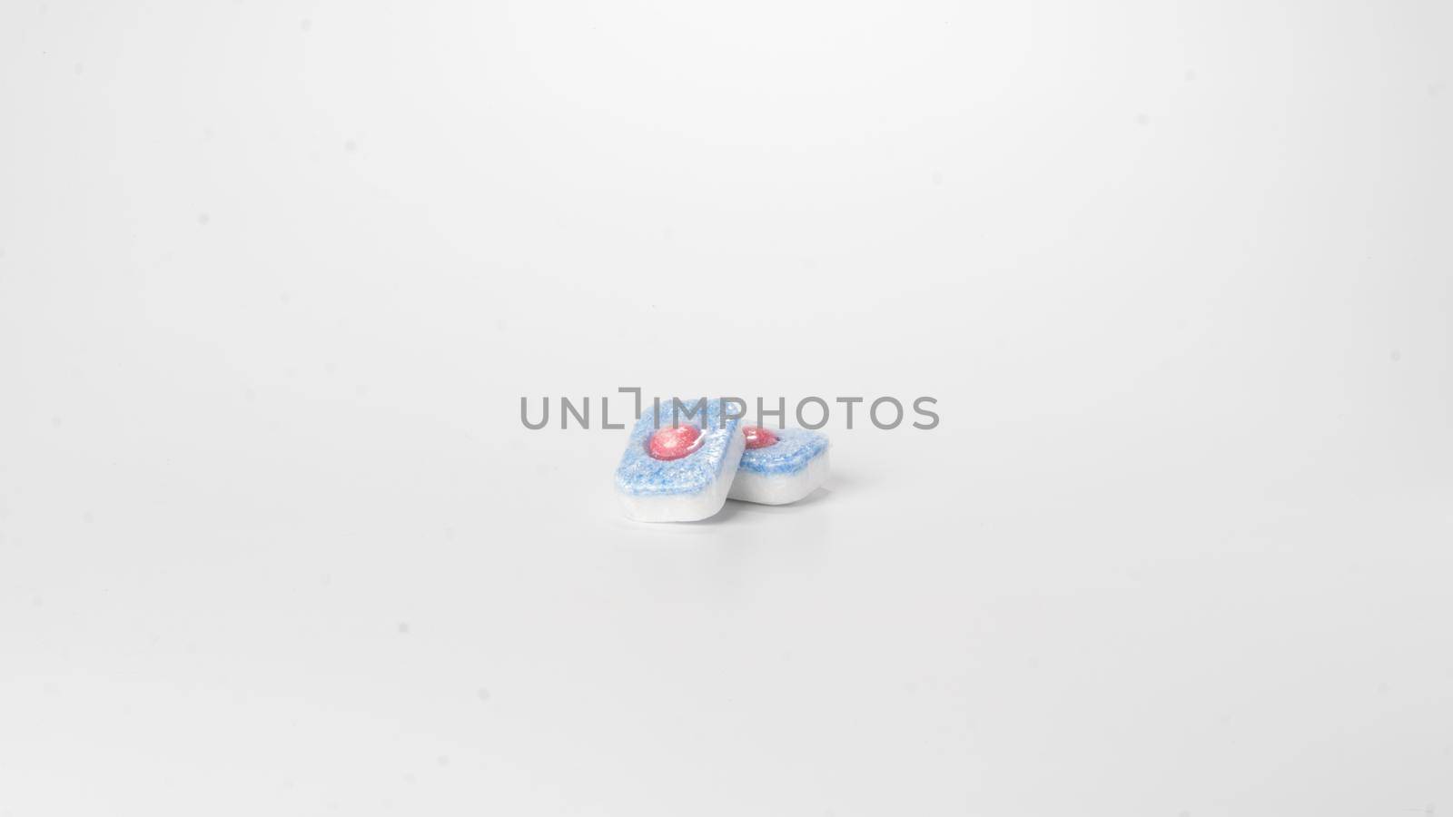 Detergent in dishwasher tablets on a white background. High quality photo