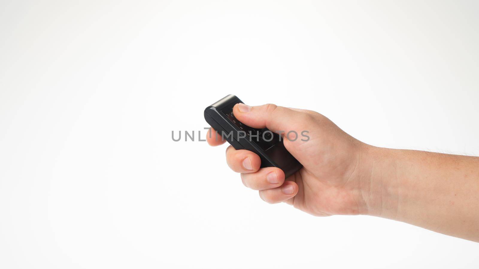 A man's hand holds a bullet control pointing upwards. High quality photo