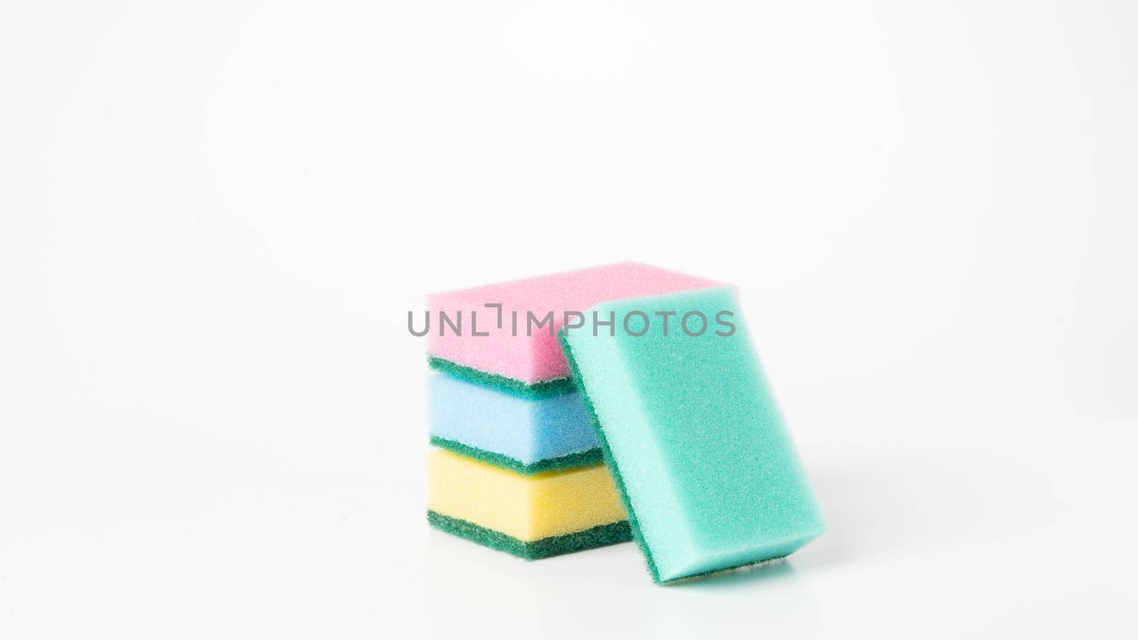 Colored sponges in a stack on a white background of the object. High quality photo