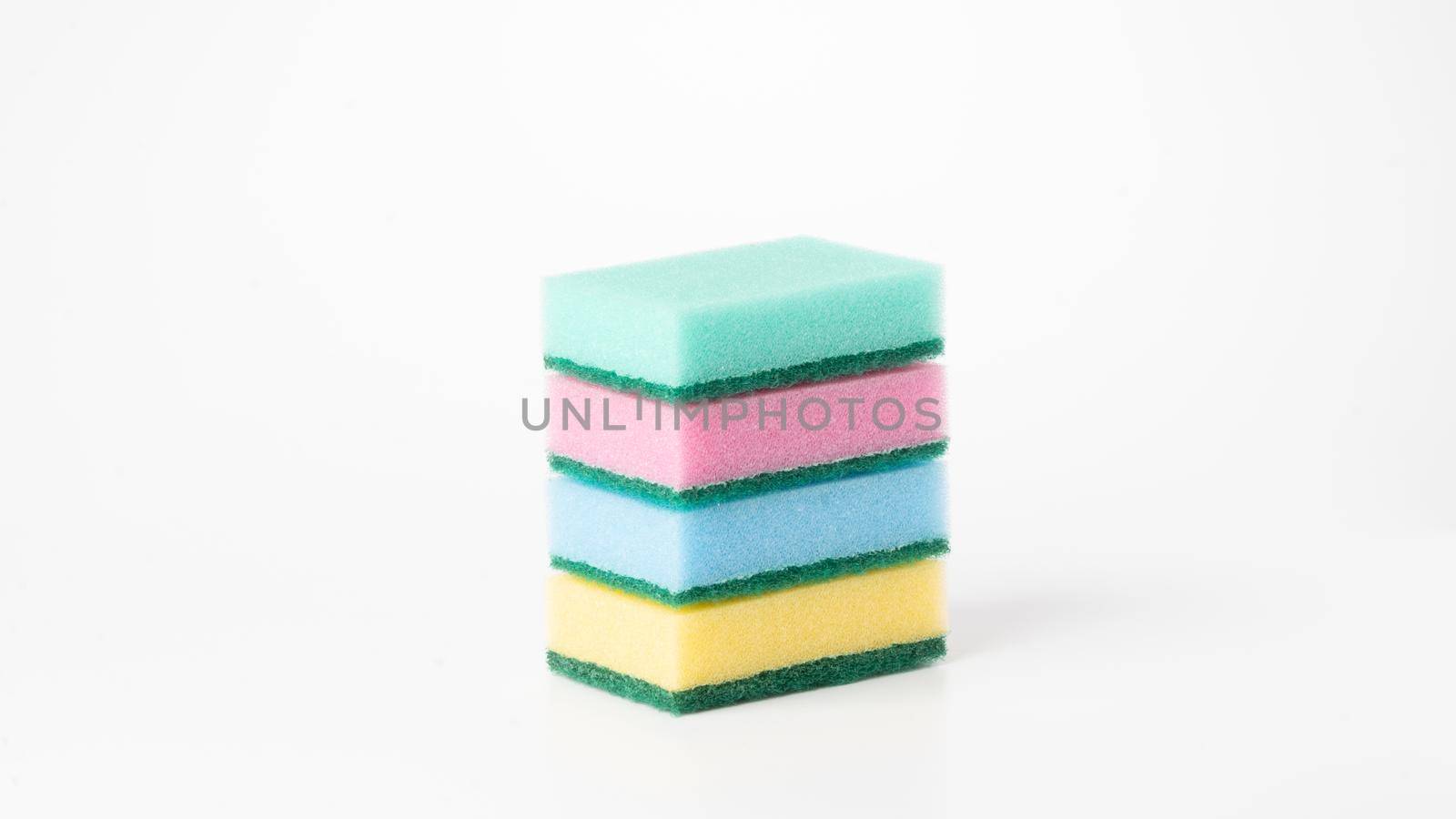 Multicolored four sponges folded into a flat stack on a white background by voktybre