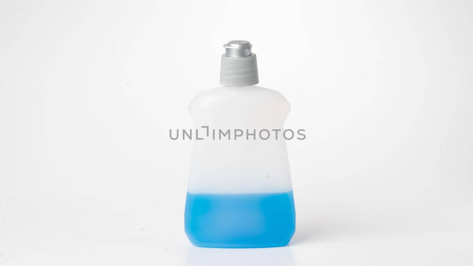 Washing liquid half filled bottle on white background by voktybre