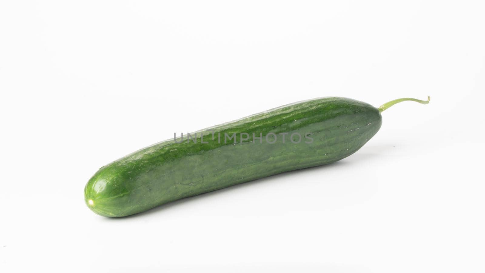 Green long cucumber on a white vegetable background by voktybre