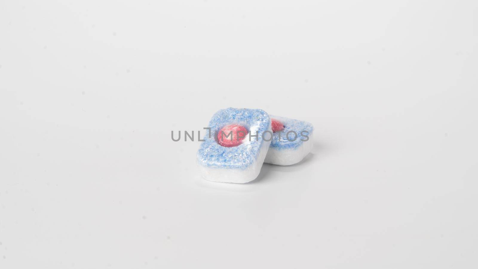 Detergent in dishwasher tablets on a white background. High quality photo