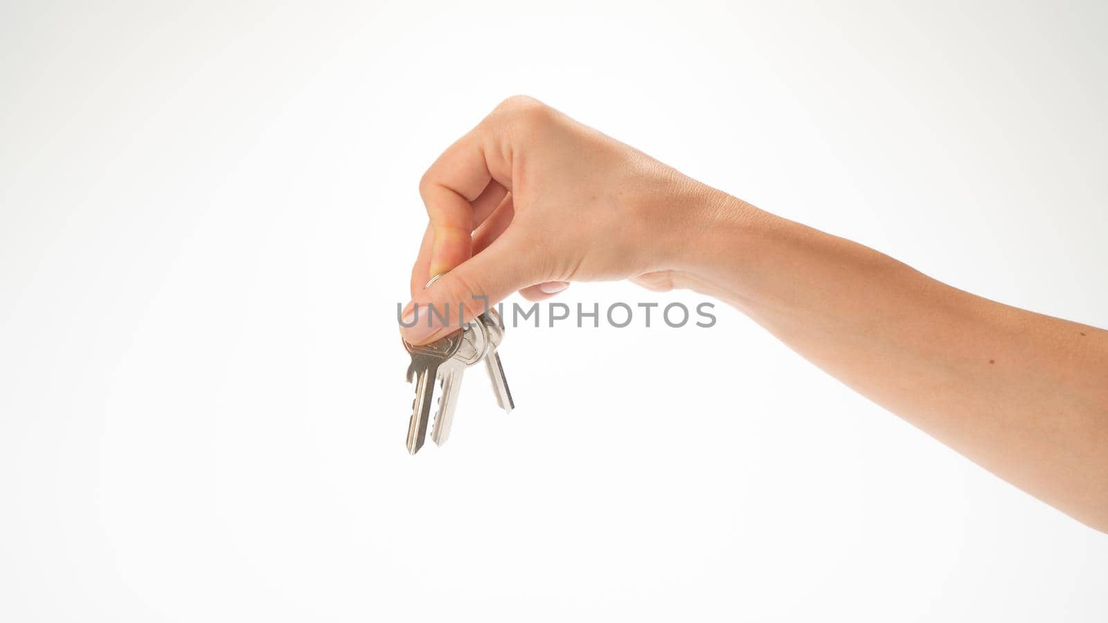A woman's hand holds a bunch of keys on a white background by voktybre