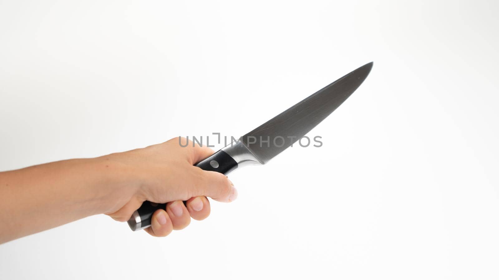 Kitchen knife in a man's hand, holds diagonally on a white background. High quality photo