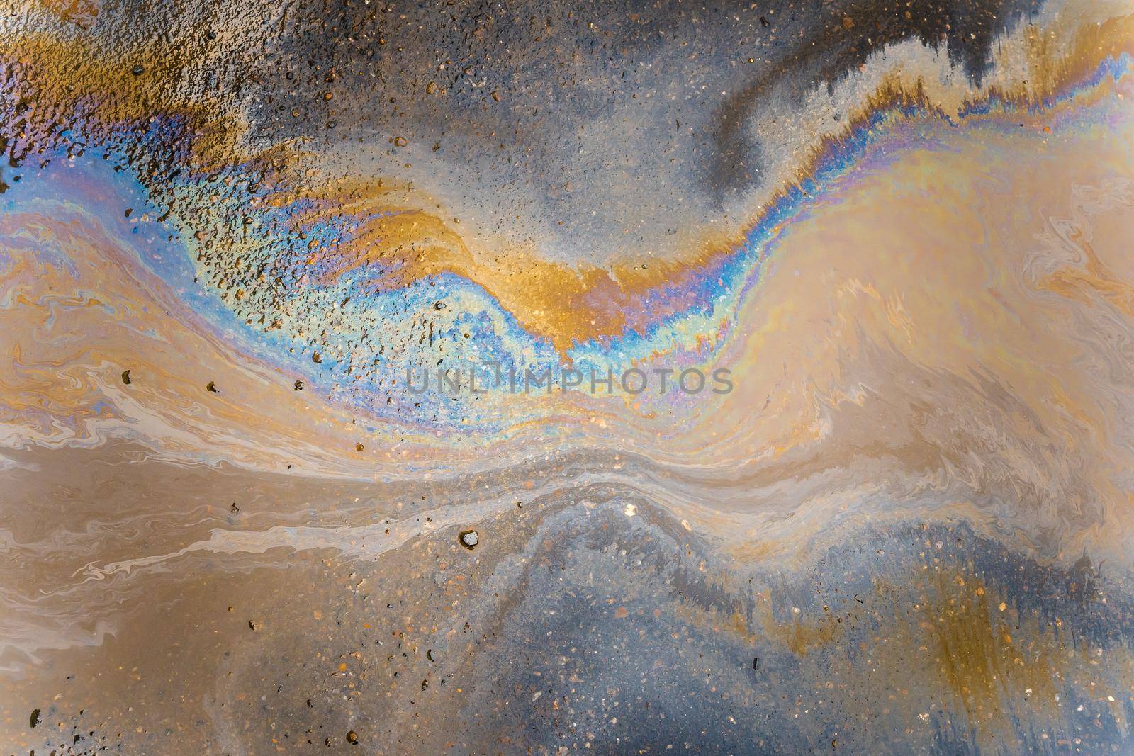 Color Gasoline fuel spots on Asphalt Road as Texture or Background. Environmental pollution concept