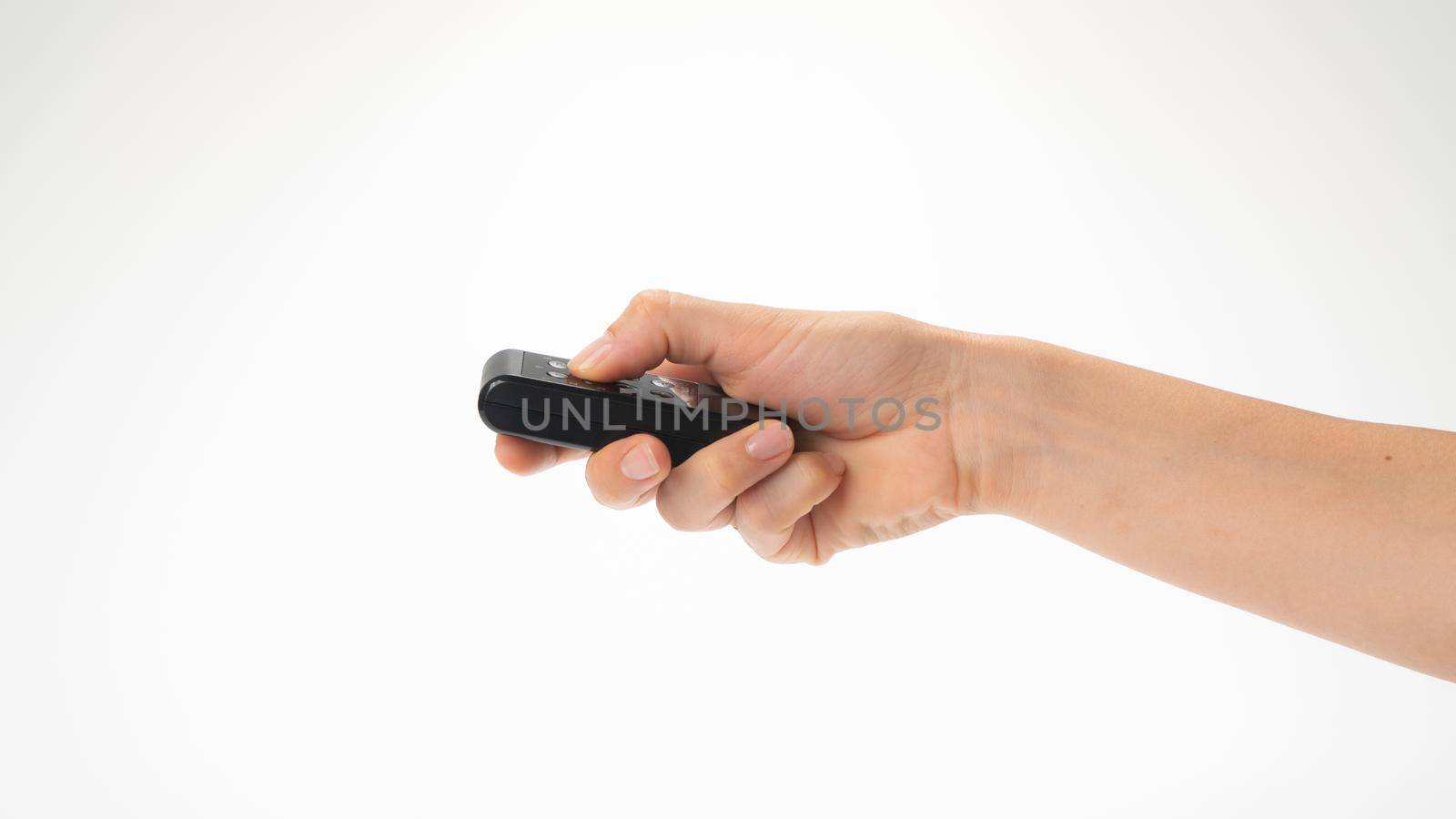 Right female hand horizontally holds the remote control. High quality photo