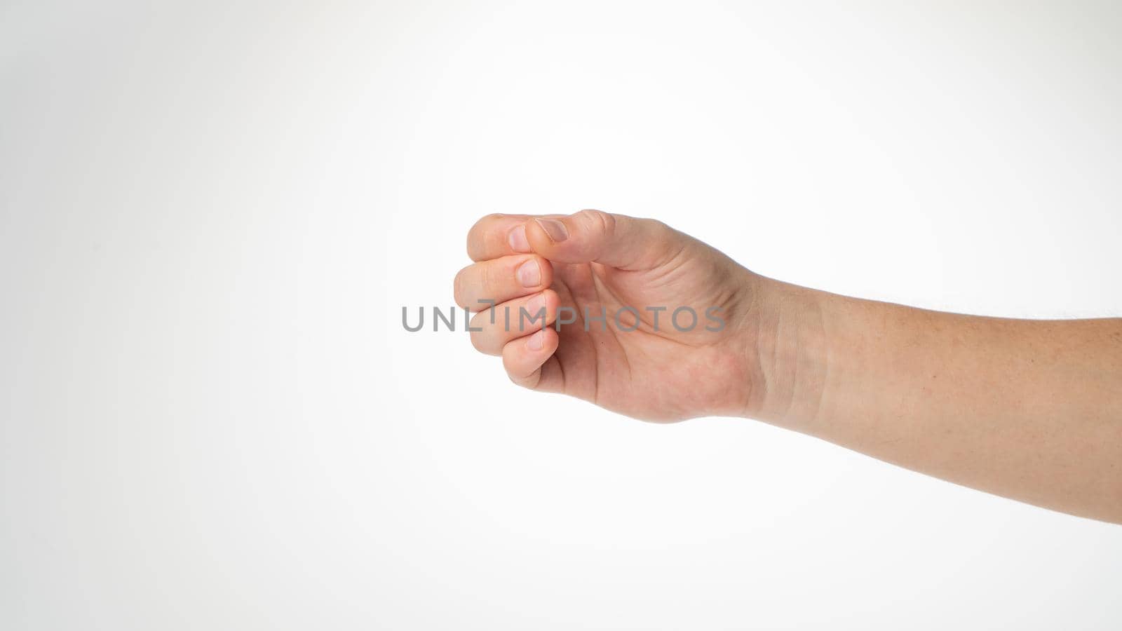 Hand male gesture fingers clenched into a ring holding a cylinder. High quality photo